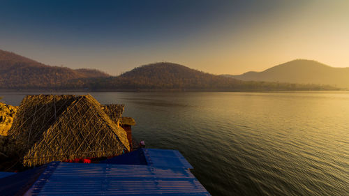 Scenic view of lake against sky during sunset