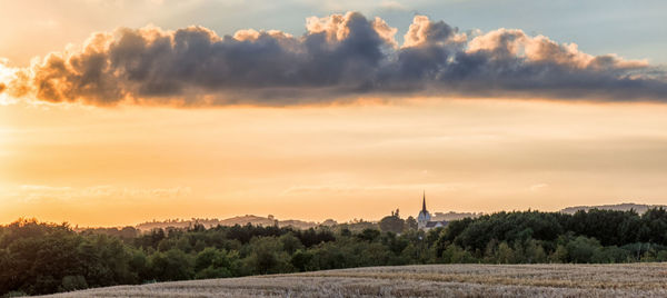 Panoramic view of field against sky during sunset