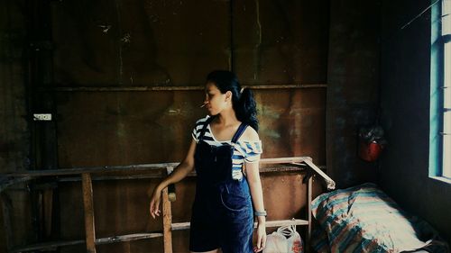Woman standing in abandoned building