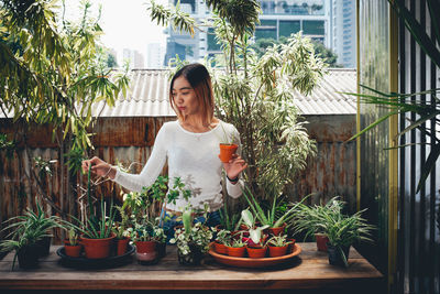 Woman looking at potted plants