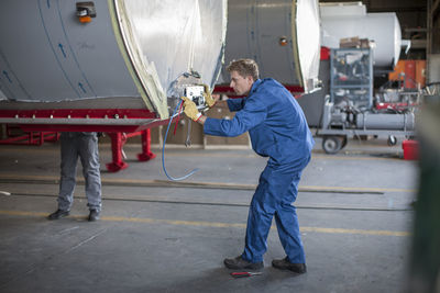 Industrial worker checking containers settings