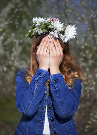 Close-up of woman covering face with hands