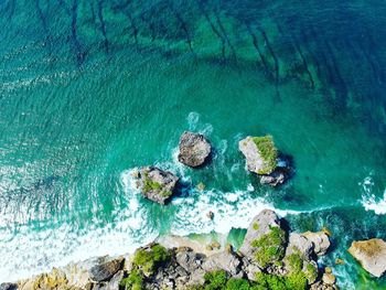 High angle view of rocks on sea shore