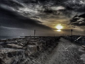 Scenic view of beach against sky during sunset