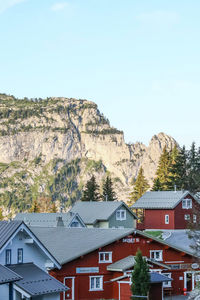 Houses on mountain against clear sky