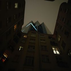 Low angle view of buildings against sky at night