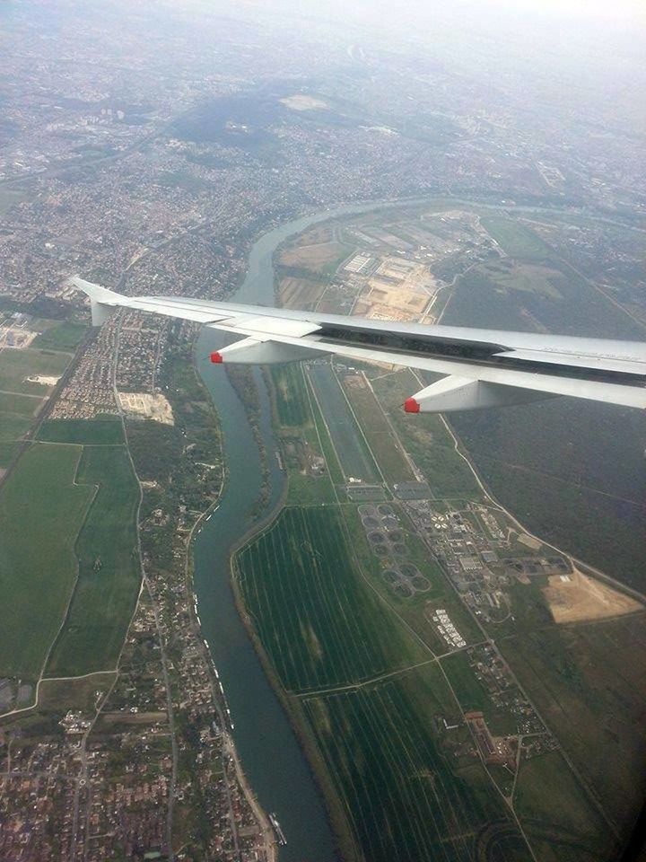 transportation, aerial view, mode of transport, airplane, air vehicle, flying, high angle view, aircraft wing, on the move, landscape, travel, public transportation, city, journey, cityscape, road, mid-air, built structure, architecture, day