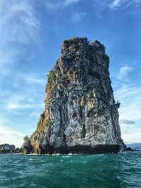 Rock formation in sea against sky
