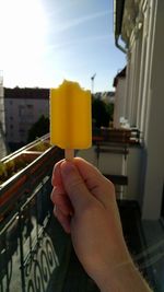 Close-up of hand holding ice cream in city