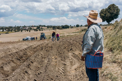 Rear view of man walking on field