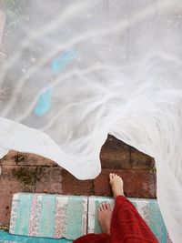 Low section of woman walking on staircase