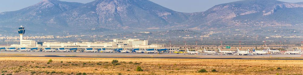 Scenic view of land and mountains against sky