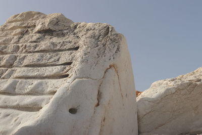 Low angle view of rock formation against sky