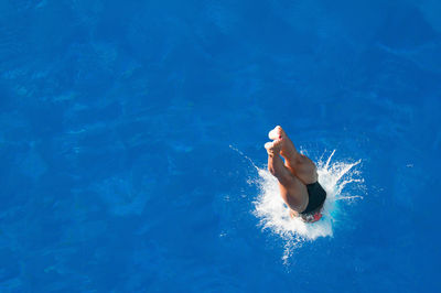 High angle view of mid adult woman diving in pool