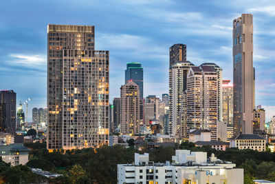 View of skyscrapers against cloudy sky