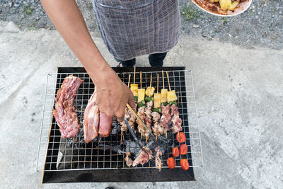 High angle view of people on barbecue grill