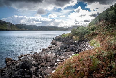 Scenic view of lake against cloudy sky