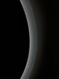 Close-up of illuminated lighting equipment against black background