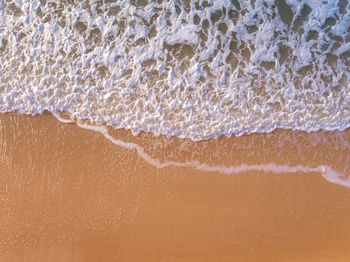 High angle view of waves on beach
