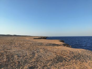 Scenic view of sea against clear blue sky