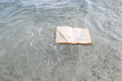 High angle view of book floating on water