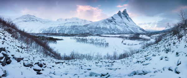 Scenic view of snow covered mountains against sky