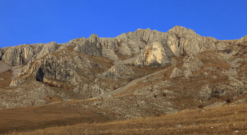 Scenic view of rocky mountains against clear blue sky