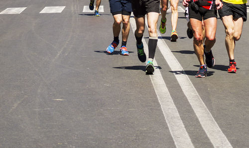 Low section of people running on road