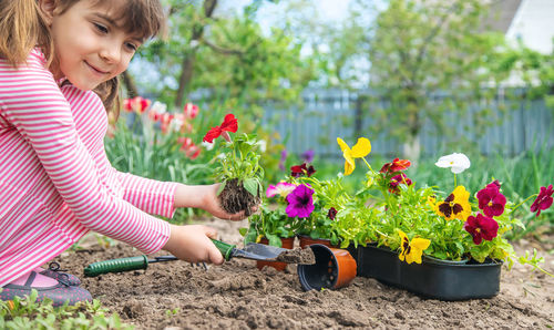 Portrait of cute girl gardening in yard