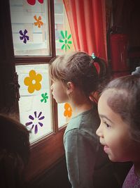 Girls standing by window