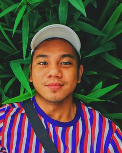 Portrait of young man against plants