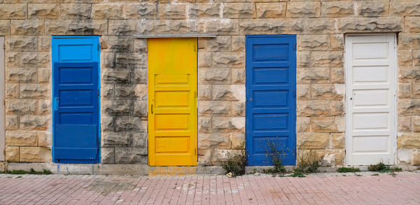 Traditional vintage painted wooden door and exterior in malta. entrance to typical maltese houses.