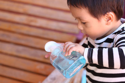 Close-up of boy drinking water