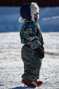 Full length of girl with arms raised in sea