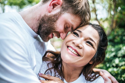 Close-up of happy couple embracing outdoors