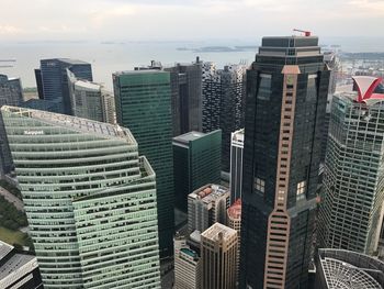 High angle view of modern buildings in city against sky