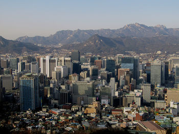 High angle view of buildings in city against clear sky