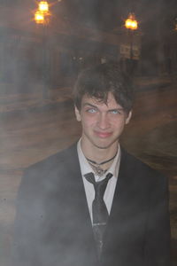 Portrait of young man standing at night