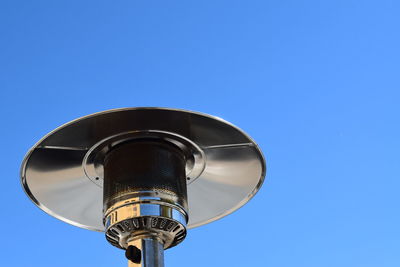 Low angle view of communications tower against blue sky