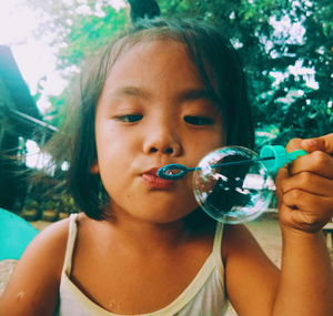 Close-up of girl blowing bubble