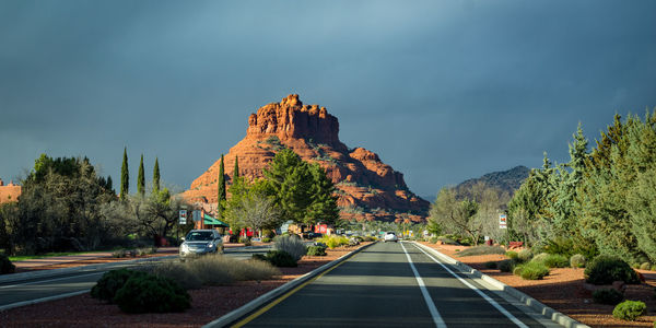 Panoramic view of road by mountain against sky