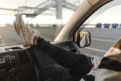 Low section of person wearing shoes in car
