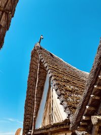 Low angle view of building against clear blue sky