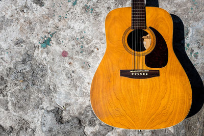 High angle view of guitar against wall