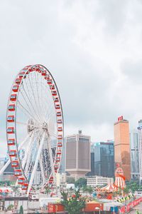 Ferris wheel in city against sky