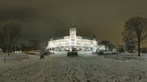 Statue in city at night