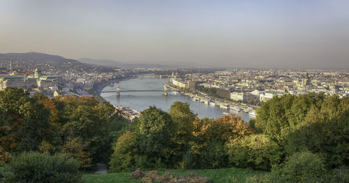 High angle view of bridge over river in city against sky