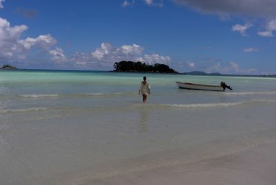 People on beach against sky