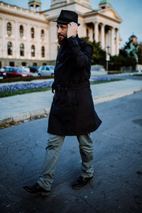 Full length of man standing on street in city