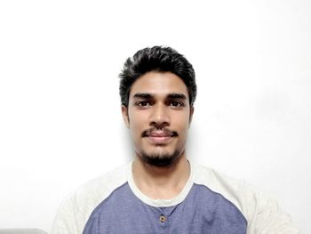 Portrait of young man against white background